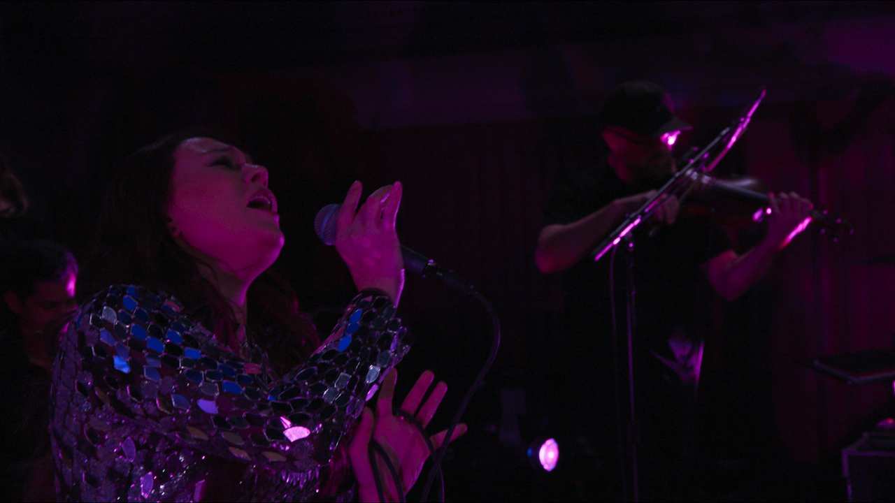 a woman singing into a microphone